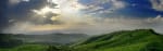 Sunlight penetrating dark clouds over deep canyon - All About Spirituality Banner